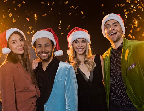Gut gelaunte Gäste mit Weihnachtsmützen